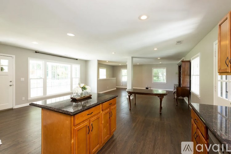 A kitchen with wooden cabinets and a black countertop.