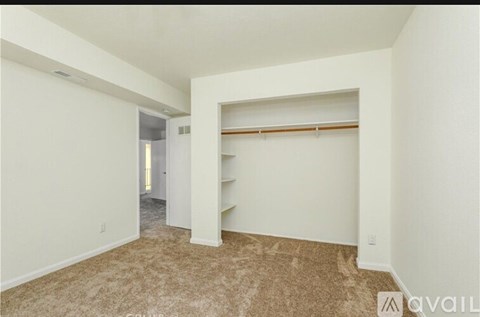 A room with a carpeted floor and a white wall.