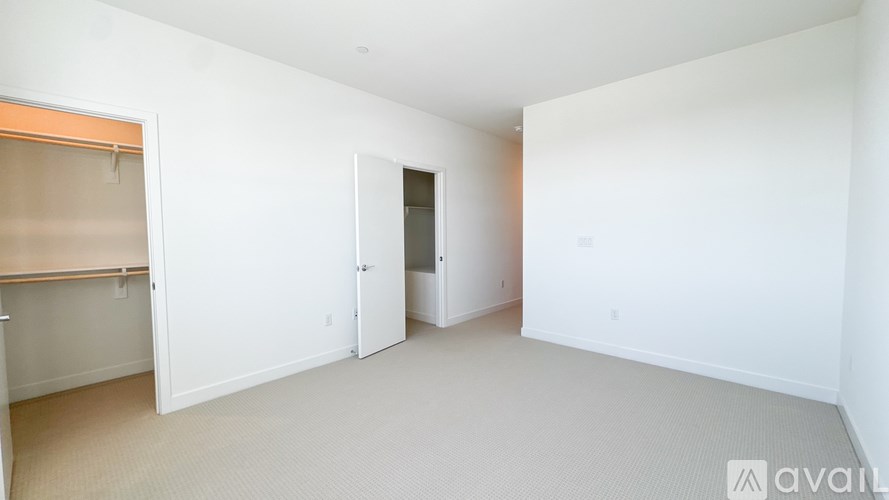 A white room with a door and a window.