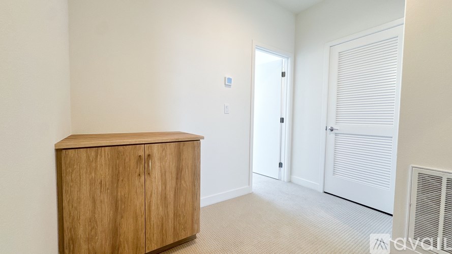 A room with a wooden cabinet and a door.