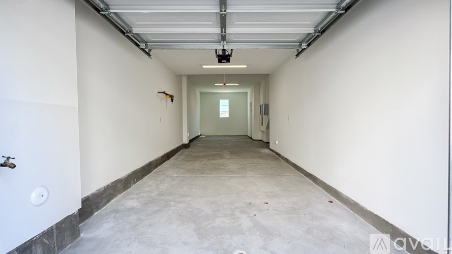 A long, empty hallway with a door at the end.