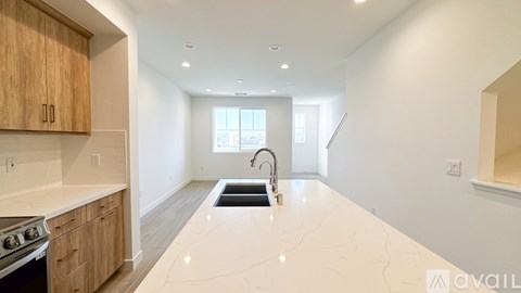 A kitchen with wooden cabinets and a white countertop.