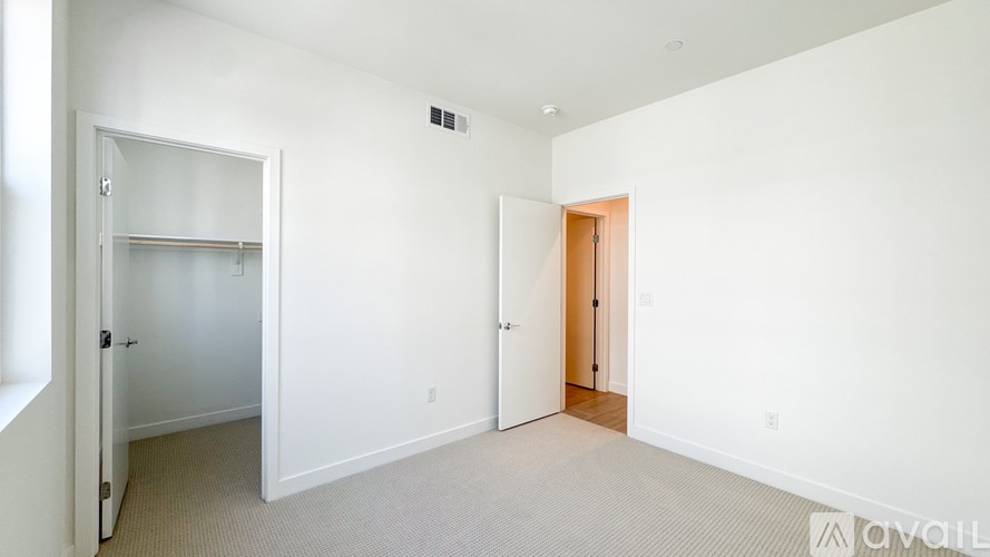 A white room with a door on the left and a door on the right.