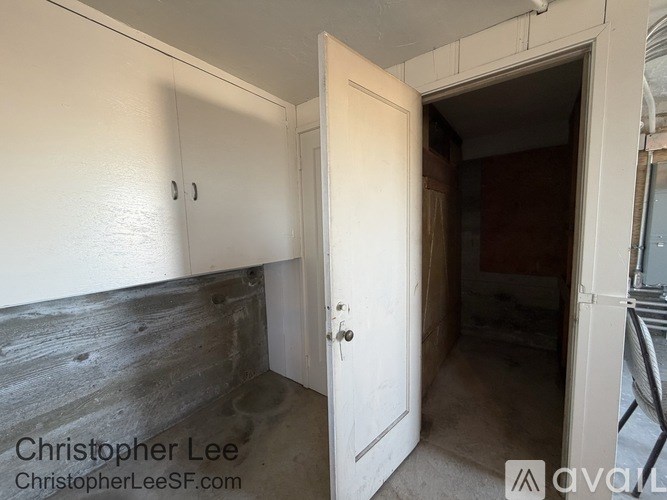 A room with a white door and a white cabinet with two holes on it.