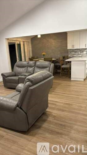 A living room with a grey sofa and a fireplace.