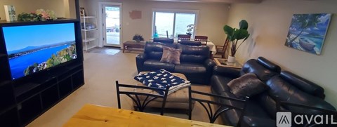 A living room with a television and a couch.