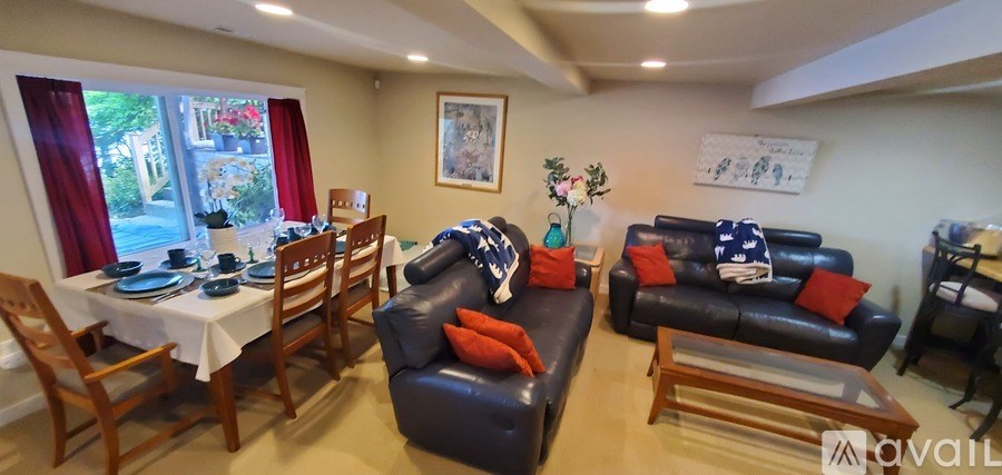 A living room with a dining table and chairs.