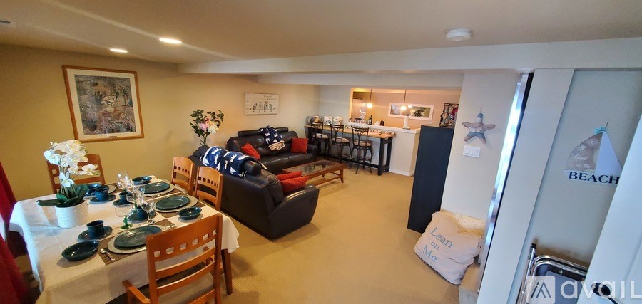 A dining room with a table set for a meal.