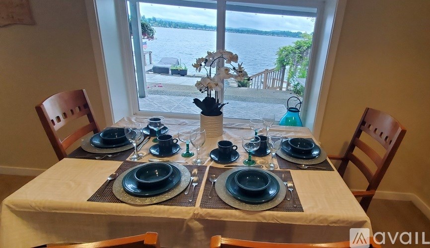 A table set for a meal with a view of the street outside.