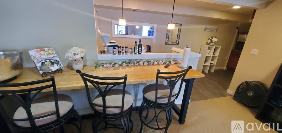 A kitchen with a bar area and chairs.