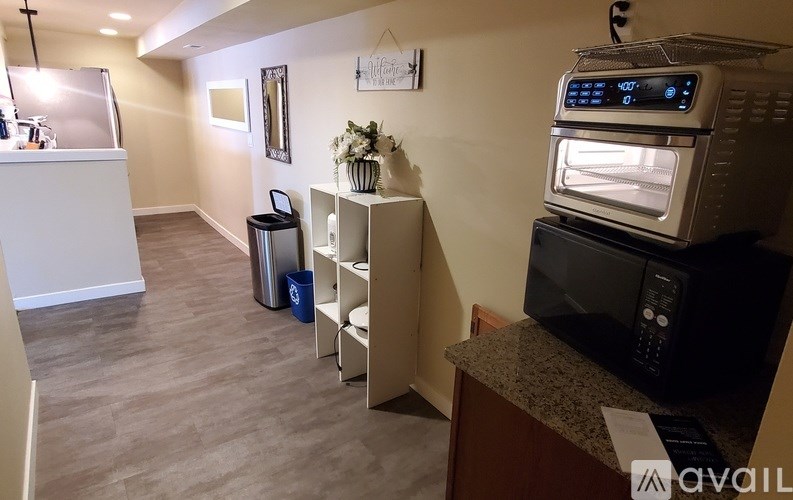 A kitchen area with a microwave, oven, and a fridge.