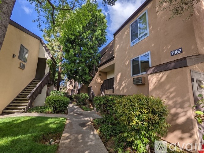 Apartment building 7962 with a pathway leading to the entrance.