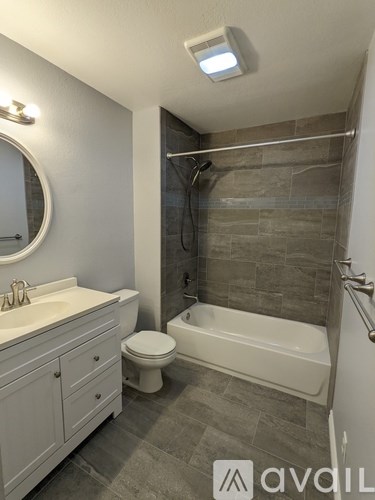 A bathroom with a toilet, sink, and bathtub.