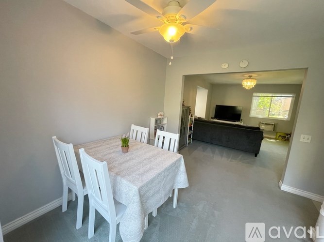 A dining room with a table set for four.
