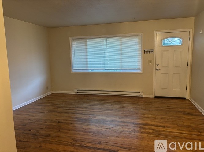 A room with wooden floors and a white door.