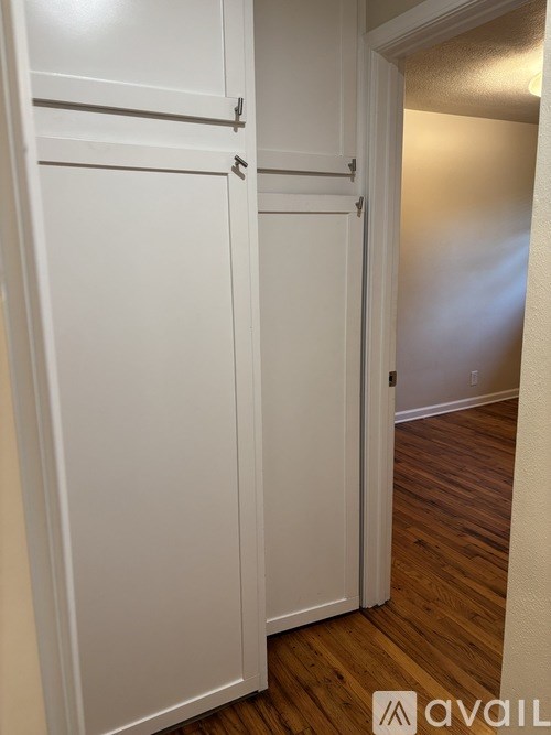 Closed white doors in a hallway.