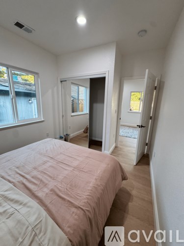 A bedroom with a bed and a window.