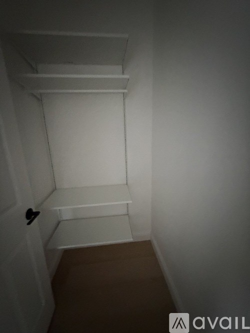 A hallway with a blue door at the end.