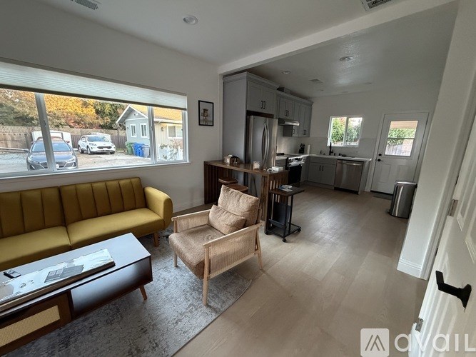 A room with a long table and chairs with a window on the right side.