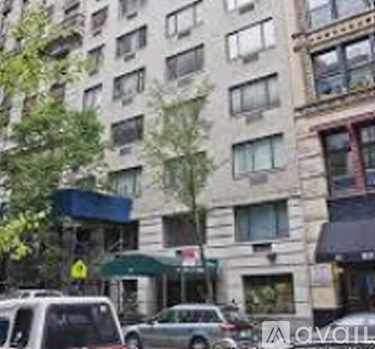 A tall building with a green awning is in the background.