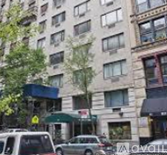 A tall building with a green awning is in the background.