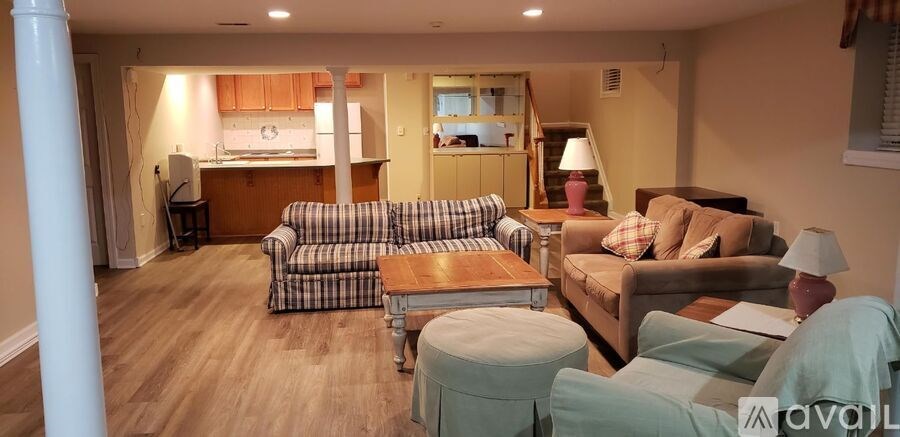 A living room with a couch, chair, and table.