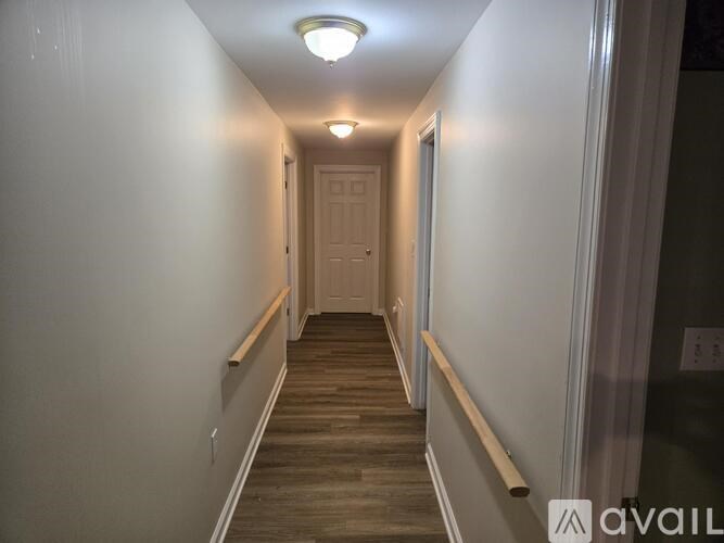 A long hallway with a door at the end.