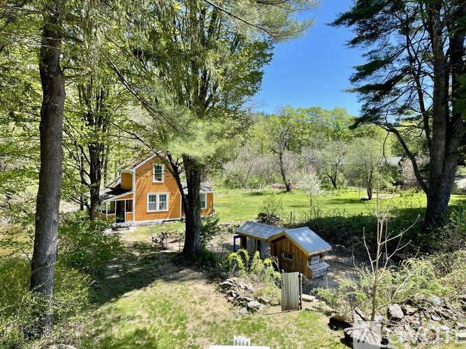 A house is surrounded by trees and grass.