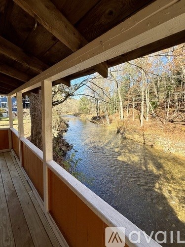 A wooden deck overlooks a river.