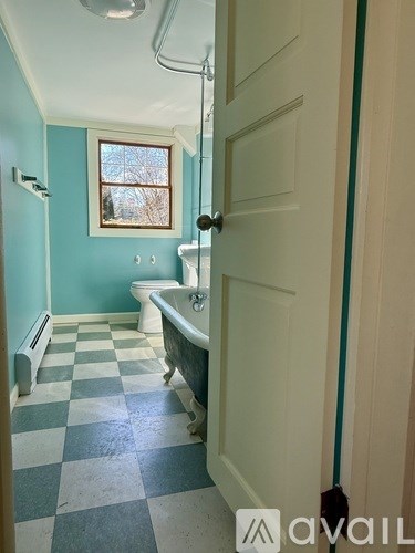 A bathroom with a blue and white checkered floor.