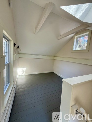 A room with a window and a skylight.