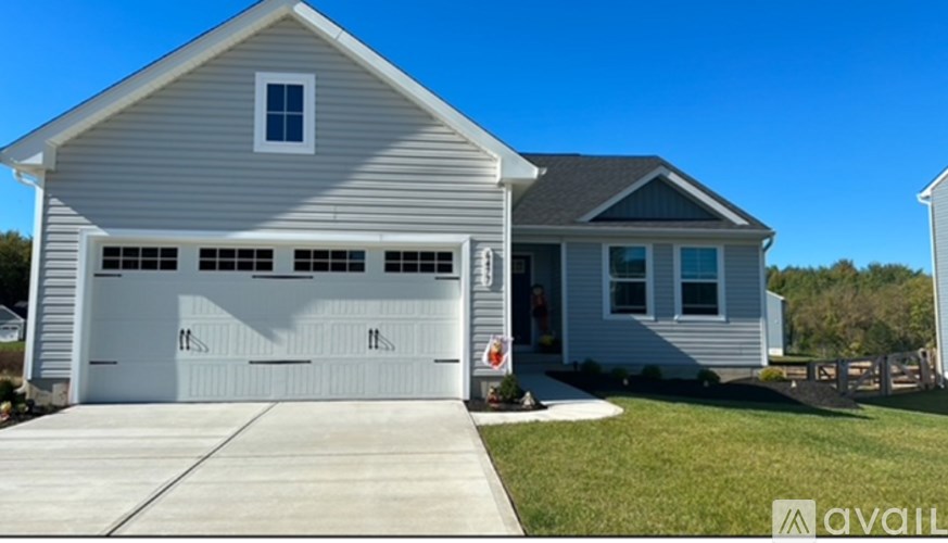 A two-story house with a garage is available for purchase.