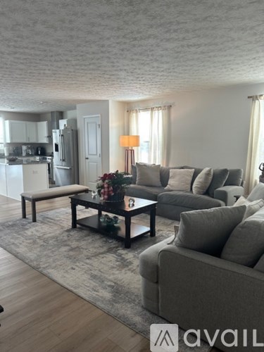A living room with a grey couch and a coffee table.