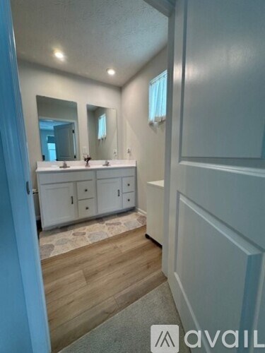 A bathroom with a vanity and a mirror.