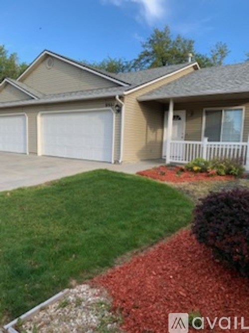 A house with a brown roof and a white garage door.