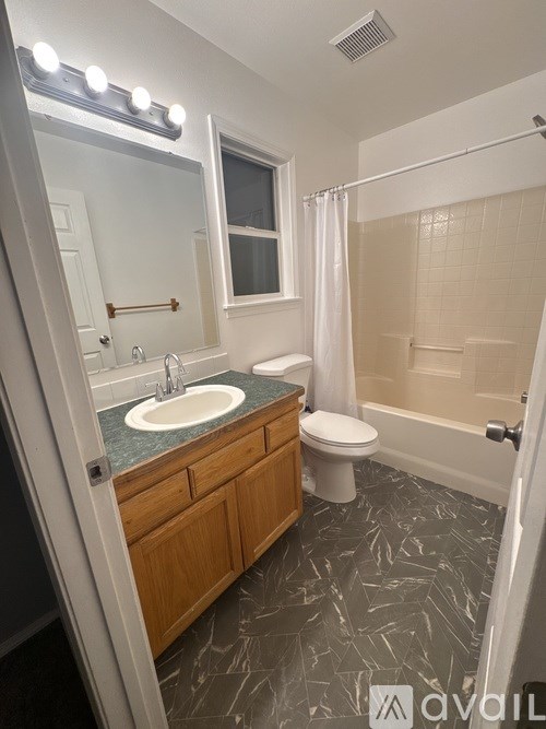 A room with a grey floor and a white door.