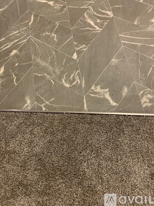 A close up of a marble patterned surface with a logo in the bottom right corner.