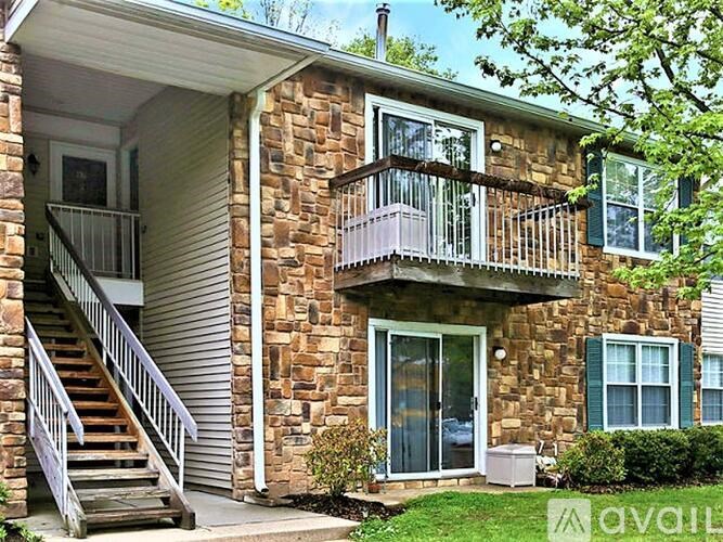 A house with a stone facade and a balcony.