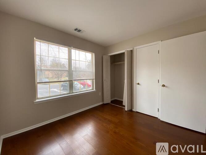 A room with a window and a door is available for rent.