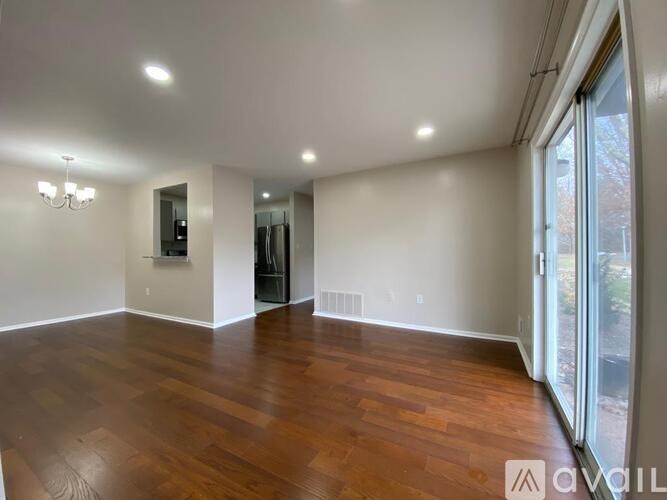 A room with wooden floors and a chandelier.