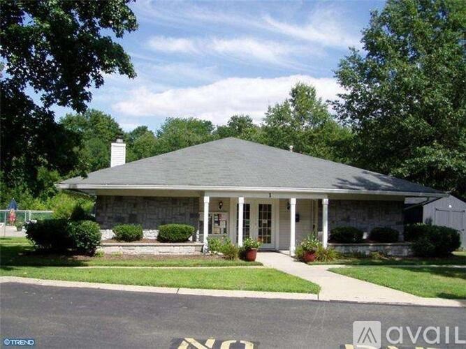 A house with a green lawn and a "No Parking" sign in front.