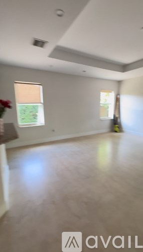 A room with a window and a lamp on the table.