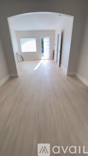 A long hallway with a window at the end.