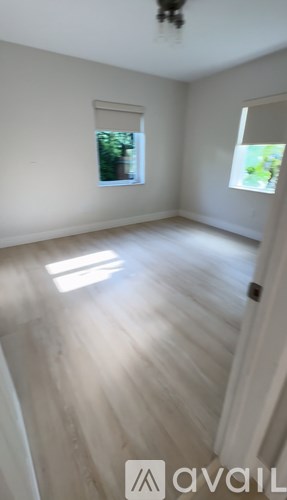 A room with a window and a door.