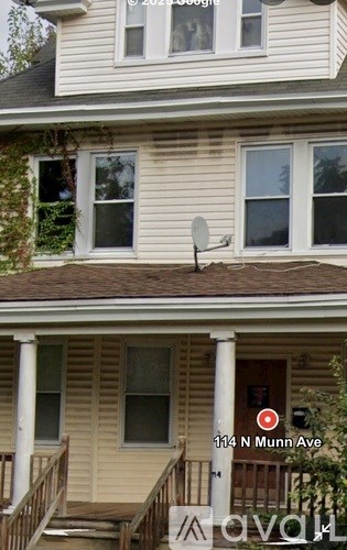 A house with a satellite dish on the roof.
