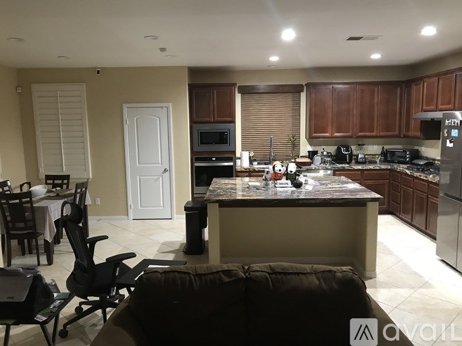 A kitchen with a table and chairs in the foreground.