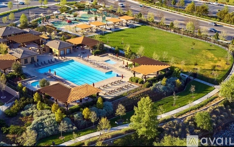 A bird's eye view of a resort with a swimming pool and multiple buildings.