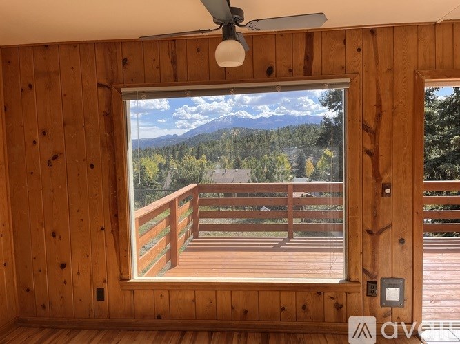 A room with wooden walls and a ceiling fan.