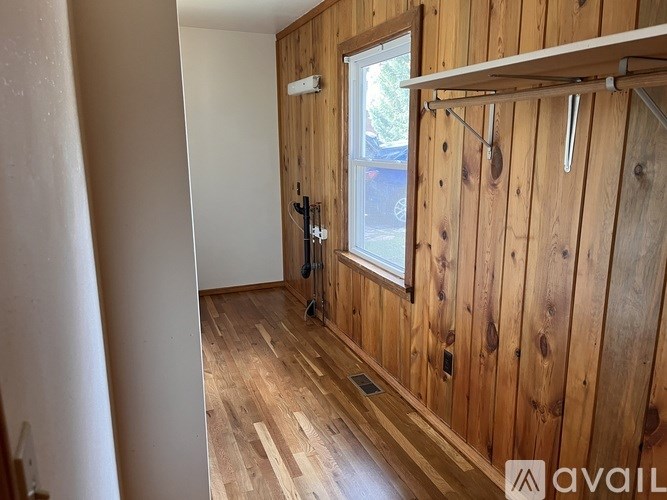 A room with wooden walls and a window.