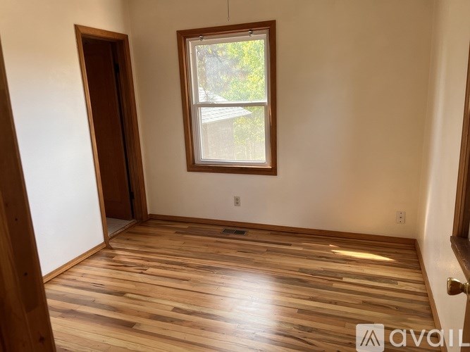 A room with wooden floors and a window.
